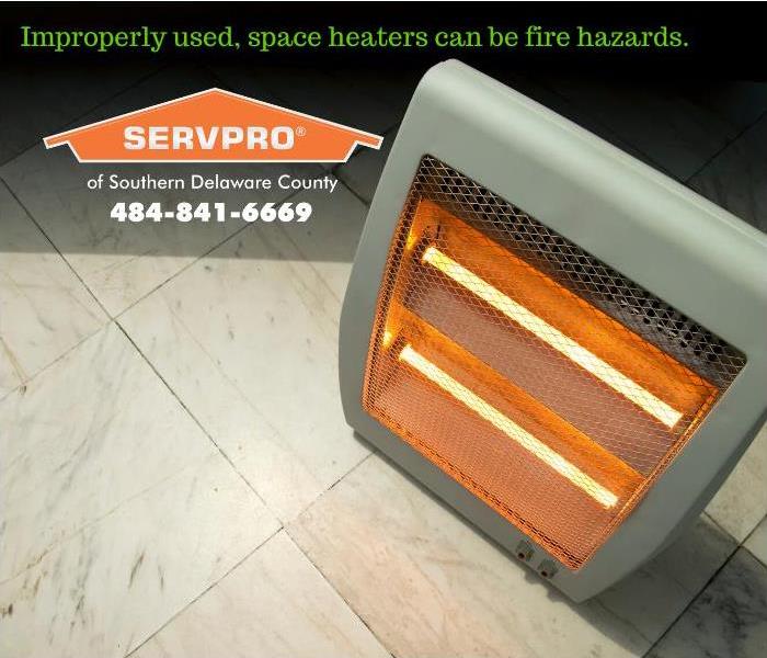 A space heater is shown operating in an unattended in a room. 